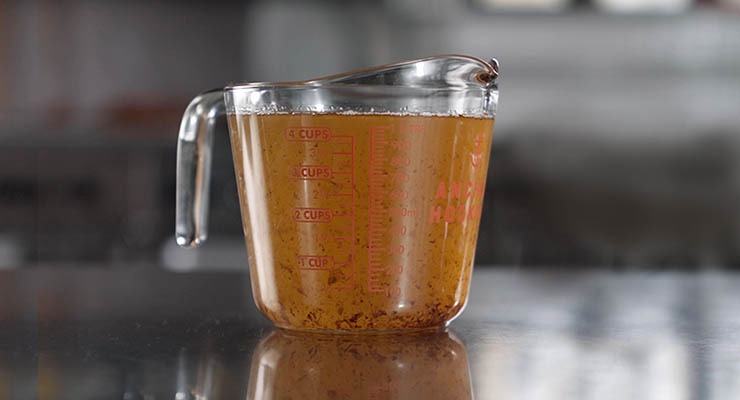 Measuring cup filled with grease